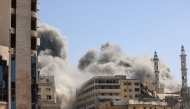Smoke billows as Israeli airstrikes destroy the al-Ghafari tower in Gaza City on September 15, 2025. Photo by Omar AL-QATTAA / AFP