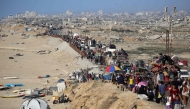 :Displaced Palestinians move with their belongings southwards on a road in the Nuseirat refugee camp area in the central Gaza Strip following renewed Israeli evacuation orders for Gaza City on September 16, 2025. (Photo by Eyad Baba / AFP)
