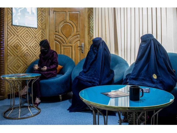 In this photograph taken on August 31, 2025, Afghan burqa-clad women, having appointments for laser treatments, sit in a waiting room at a beauty clinic in Kabul. (Photo by Wakil Kohsar / AFP)