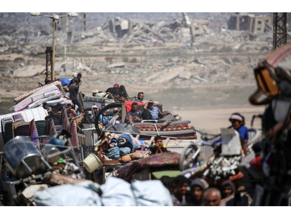 Palestinians from Gaza City move southwards with their belongings, on the coastal road near the Nuseirat refugee camp in the central Gaza Strip, on September 19, 2025. (Photo by Eyad BABA / AFP)
