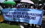 Protesters hold a banner which reads 