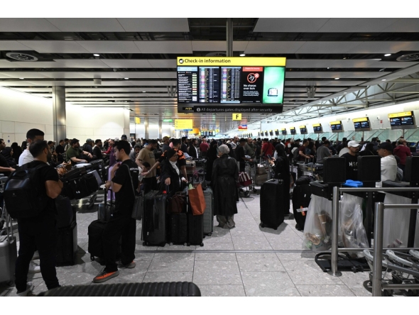 Travellers wait in terminal 4 at Heathrow Airport, west of London on September 20, 2025. Photo by JUSTIN TALLIS / AFP