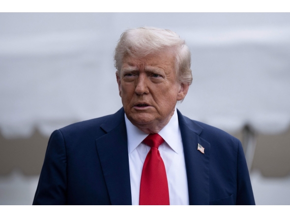 US President Donald Trump stops to speak with reporters while walking to Marine One on the South Lawn of the White House September 21, 2025, in Washington, DC. Trump is heading to Glendale, Arizona to attend the public memorial service for Charlie Kirk. (Photo by Brendan Smialowski / AFP)

