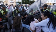 Members of the security forces detain a protester as others scuffle during a youth-led demonstration in Rabat on September 29, 2025, calling for reforms in the public health and education sectors. Dozens of youths were detained on September 29 in Morocco on the third day of protests calling for education and public health reforms, according to a local rights group and AFP reporters. (Photo by Abdel Majid Bziouat / AFP)

