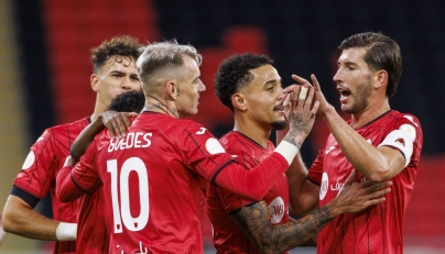 Al Rayyan's Roger Guedes (centre) celebrates with teammates.