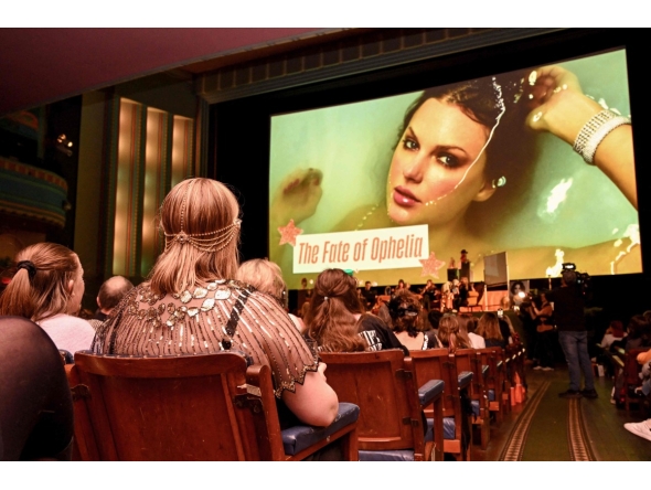 Taylor Swift fans listen to a song during a listening event for Swift's new album 'The Life of a Showgirl' at the Astor Theatre in Melbourne on October 3, 2025. Photo by William WEST / AFP