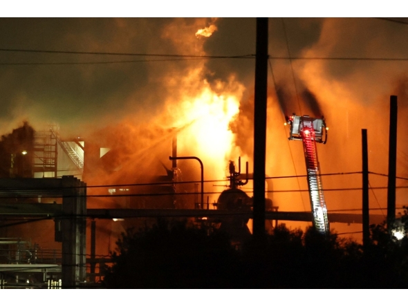 A firefighting crew works to contain a fire at the Fire Chevron Products Company El Segundo Refinery in the early morning hours on October 3, 2025, in El Segundo, California, following an explosion at the oil refinery that occurred late on October 2. Photo by Patrick T. Fallon / AFP