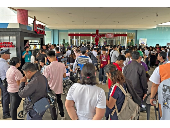 People gather outside a mall in Butuan City, on the southern island of Mindanao on October 10, 2025, after a 7.4-magnitude earthquake struck off the southern Philippines. (Photo by Erwin MASCARINAS / AFP)