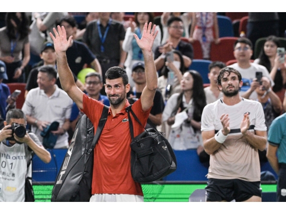 Serbia's Novak Djokovic acknowledges spectators after losing in his men's singles semi-final match against Monaco's Valentin Vacherot on October 11, 2025. (Photo by Hector Retamal / AFP)