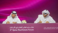 Aqarat Chairman Eng. Khalid bin Ahmed Al Obaidli with one of the officials during the signing of an MoU on the second day of Third Qatar Real Estate Forum, yesterday.