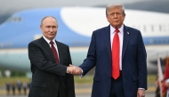 (FILES) US President Donald Trump greets Russian President Vladimir Putin on the tarmac after they arrived at Joint Base Elmendorf-Richardson in Anchorage, Alaska, on August 15, 2025. 