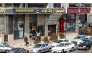 (Files) Iranians walk past an Ayandeh Bank branch (L) in the capital Tehran on January 14, 2017. (Photo by Atta Kenare / AFP)