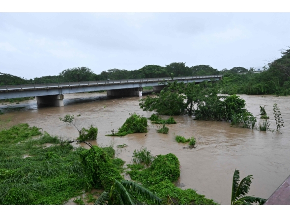 The Rio Cobre comes out of its banks near St. Catherine, Jamaica, on October 28, 2025. (Photo by Ricardo Makyn / AFP)
