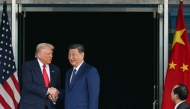 US President Donald Trump (L) and China's President Xi Jinping shake hands as they leave after their talks at the Gimhae Air Base on October 30, 2025. (Photo by Andrew Caballero-Reynolds / AFP)
 