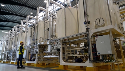 A worker looks at a row of machinery in Everfuel's new HySynergy electrolysis plant in Fredericia, Denmark, on November 3, 2025. Photo by James BROOKS / AFP