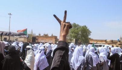 A Sudanese Student flashes the V-sign for victory as schools in the East Nile region of the capital gather during a protest against violations committed by the Rapid Support Forces (RSF) against the people of El- Fasher, in Khartoum on November 3, 2025. (Photo by Ebrahim Hamid / AFP)
