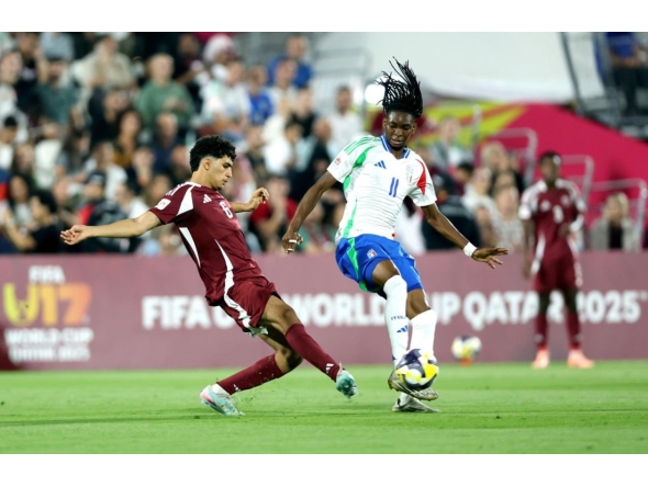 Qatar's Adam Friakh (left) and Italy's Destiny Elimoghale vie for the ball possession. 