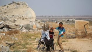 Displaced Palestinian children collect branches and twigs to use for cooking amid fuel shortage in the village of Juhr al-Dik, east of the Bureij refugee camp in the central Gaza Strip, on November 3, 2025. (Photo by Eyad Baba / AFP)
