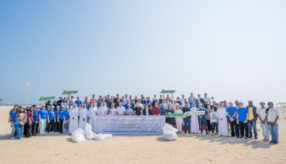 UDST President Dr. Salem Al-Naemi with staff and students during the beach cleanup initiative at Al Wakrah Public Beach.