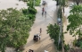 People wade through the water along a submerged street in Tuguegarao City, Cagayan province, north of Manila on November 11, 2025, as flood waters continue to inundate homes due to heavy rains brought about by Super Typhoon Fung-wong. Photo by John Dimain / AFP