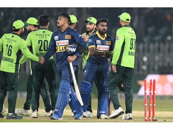 Sri Lanka's Maheesh Theekshana (CL) and Sri Lanka's Asitha Fernando (CR) shake hands with Pakistan's players at the end of the first one-day international (ODI) cricket match between Pakistan and Sri Lanka at the Rawalpindi Cricket Stadium in Rawalpindi on November 11, 2025. (Photo by Aamir QURESHI / AFP)