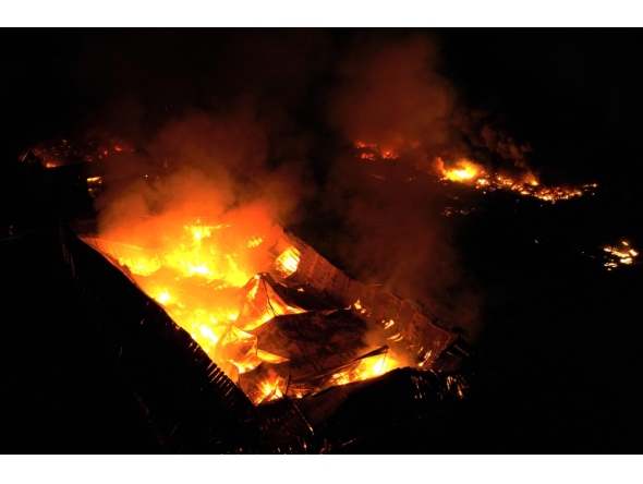This aerial view shows a fire after an explosion in an industrial area of Ezeiza, Buenos Aires province, Argentina on November 14, 2025. (Photo by Luis Robayo / AFP)