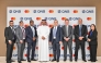 QNB and Mastercard senior executives pose for a goup photo during the signing ceremony.