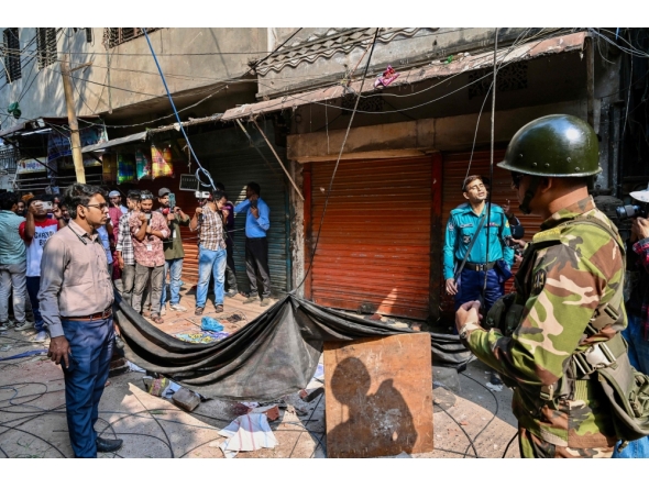 An army personnel stands guard near the rubble that fell from a damaged building following an earthquake in Old Dhaka on November 21, 2025. (Photo by Munir Uz Zaman / AFP)