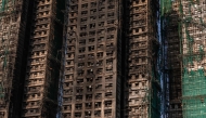 A general view shows the aftermath of a major fire that swept through several apartment blocks at the Wang Fuk Court residential estate in Hong Kong's Tai Po district on November 28, 2025. (Photo by Dale DE LA REY / AFP)
