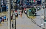 Damaged wires dangle from electric poles as an army truck wades through a flooded street after heavy rainfall in Wellampitiya on the outskirts of Colombo on November 30, 2025. (Photo by Ishara S. Kodikara / AFP)