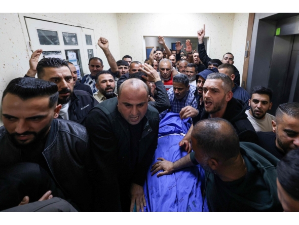 Palestinians mourn over the body of Bahaa Rashed at Rafidia hospital in Nablus after he was killed during an operation by Israeli forces in the village of Odala, south of Nablus in the occupied West Bank, on December 5, 2025. (Photo by JAAFAR ASHTIYEH / AFP)