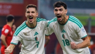 Adil Boulbina (left) and Redouane Berkane celebrate after scoring a goal.