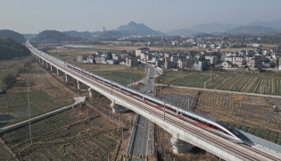 An aerial drone photo taken on Dec. 26, 2025 shows the C3132 passenger train bound for Hangzhou running along the Hangzhou-Quzhou high-speed railway in east China's Zhejiang Province. (Xinhua/Huang Zongzhi)
 