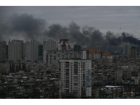 This photograph taken on December 27, 2025 shows smoke rising above residential buildings following Russian drones and missiles attack, in Kyiv, amid the Russian invasion in Ukraine. Photo by AFP