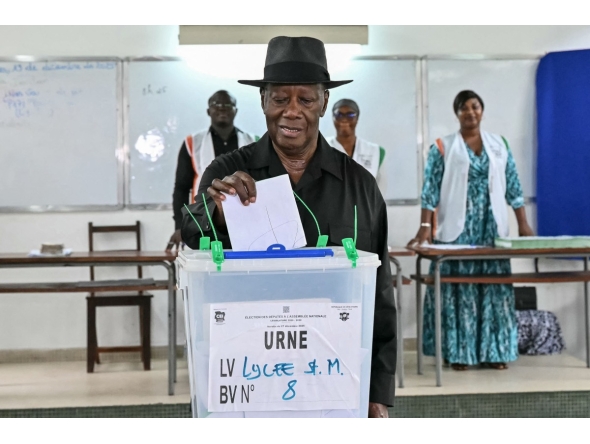 Ivory Coast's President Alassane Ouattara casts his ballot at a polling station at the Lycee Saint-Marie in Cocody, Abidjan, on December 27, 2025 during Ivory Coast's legislative elections. (Photo by SIA KAMBOU / AFP)