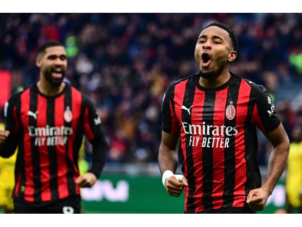 AC Milan's French forward #18 Christopher Nkunku celebrates after scoring his team second goal against Hellas Verona at the San Siro stadium in Milan. (Photo by Piero CRUCIATTI / AFP)