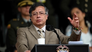 Colombia's President Gustavo Petro delivers a speech during the commemoration of the 134th anniversary of the National Police and the promotion of officers at the General Santander Police Academy in Bogota on November 13, 2025. (Photo by Raul Arboleda/ AFP)
