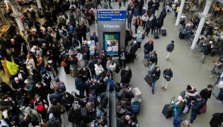 Travellers are pictured at St. Pancras station in London on December 30, 2025, as Eurostar train service between Britain and continental Europe is halted. Eurostar advised passengers to postpone their journeys to a later date, citing 