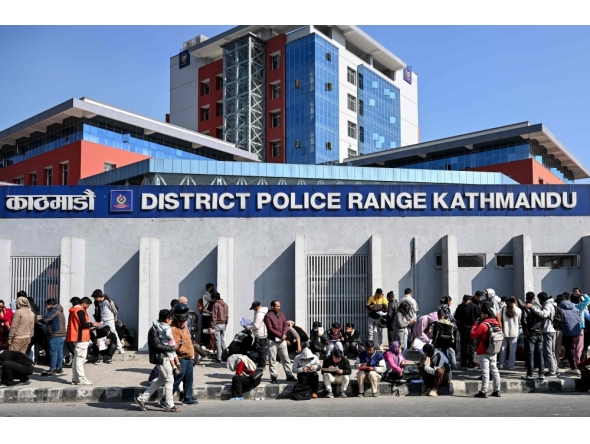 Nepali youth queue to submit applications for temporary police personnel for the upcoming general elections outside the District Police Range office in Kathmandu on January 11, 2026. (Photo by Prakash Mathema / AFP)