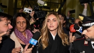 Italian influencer and businesswoman Chiara Ferragni (C), charged for aggravated fraud in a case linked to a Pandoro charity initiative, arrives in the Milan Courthouse in Milan, on January 14, 2026. (Photo by Piero CRUCIATTI / AFP)
