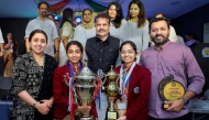 Students and teachers of Bhavan’s Public School pose with the trophies.