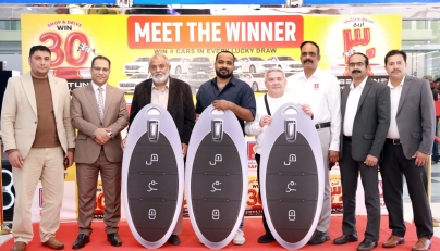 Safari Hypermarket officials with the draw winners.