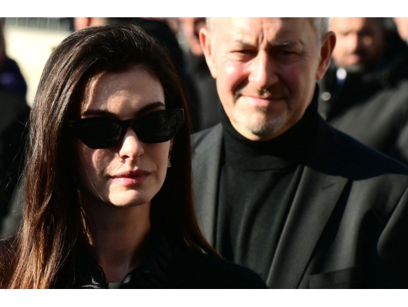 US actress Anne Hathaway arrives at the funeral ceremony for the late Italian fashion designer Valentino Gavarani at the Basilic of Santa Maria degli Angeli e dei Martiri, in Rome on January 23, 2026. (Photo by Stefano RELLANDINI / AFP)