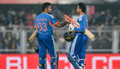 India's Abhishek Sharma and captain Suryakumar Yadav celebrate their team's win at the end of the third Twenty20 between India and New Zealand at Guwahati on January 25, 2026. (Photo by Biju BORO / AFP) 