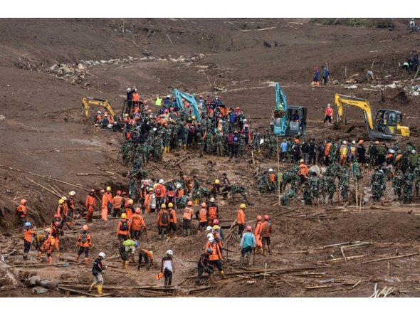 Rescuers search for victims buried by a landslide in Pasirlangu village in Bandung, West Java, on January 26, 2026. (Photo by Timur Matahari / AFP)