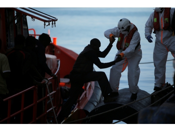 File photo: A migrant, part of a group intercepted aboard a dinghy off the coast in the Mediterranean Sea, is helped by a rescuer after arriving on a rescue boat at the port of Malaga, Spain June 22, 2018. REUTERS/Jon Nazca