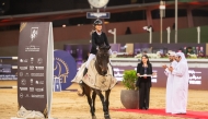 Kristen Vanderveen celebrates with her 12-year-old gelding Bull Run’s Jireh after winning the CSI5* jump-off 155cm class during the final round of the HH The Father Amir’s Prix at Al Shaqab yesterday. The winners of the class were presented trophies by Abdullah al-Qashouti, the tournament's Marketing and Communications Director.