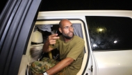 Seif al-Islam Kadhafi appears in front of supporters and journalists at his father's residential complex in the Libyan capital Tripoli in the early hours of August 23, 2011.