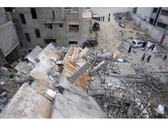 Displaced Palestinians inspect the damage after Israeli aircraft targeted a five floor house last night, in Khan Yunis southern Gaza Strip on February 6, 2026. (Photo by Bashar Taleb / AFP)