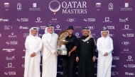 US' Patrick Reed celebrates on the podium with the trophy after winning the Qatar Masters 2026 golf tournament at Doha Golf Club in Doha on February 8, 2026. (Photo by Karim JAAFAR / AFP)
